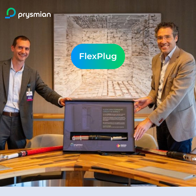 Prysmian CEO Dennis Marks and Enexis CEO Rutger van der Leeuw standing beside the FlexPlug medium-voltage substation solution during the agreement signing event.